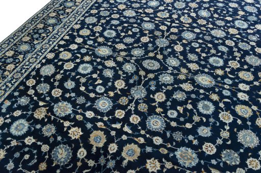 Backside of handmade 2000s Kashan rug showing knot structure and weave density