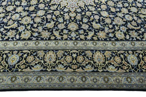 Corner detail of 2000s Kashan rug showing border pattern and Wool pile