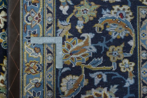 Backside of handmade 2000s Kashan rug showing knot structure and weave density