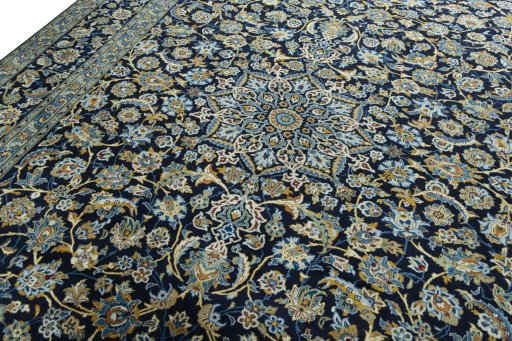 Backside of handmade 2000s Kashan rug showing knot structure and weave density