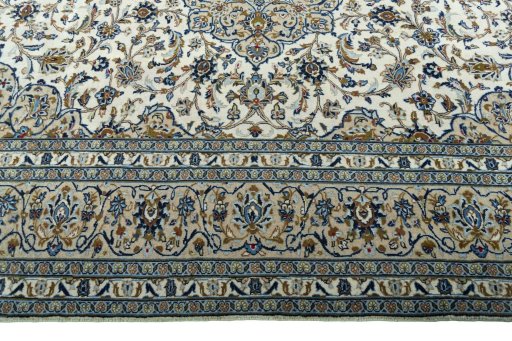 Corner detail of 2000s Kashan rug showing border pattern and Wool pile