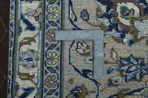 Backside of handmade 2000s Kashan rug showing knot structure and weave density