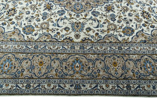 Corner detail of 2000s Kashan rug showing border pattern and Wool pile