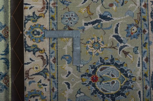 Backside of handmade 2000s Kashan rug showing knot structure and weave density