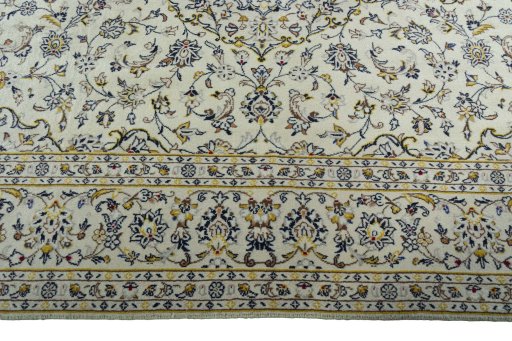 Corner detail of 2000s Kashan rug showing border pattern and Wool pile