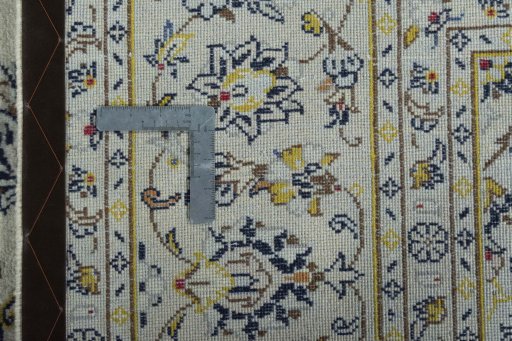 Backside of handmade 2000s Kashan rug showing knot structure and weave density