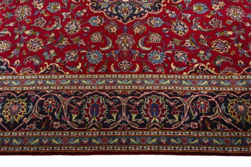 Corner detail of 2000s Kashan rug showing border pattern and Wool pile