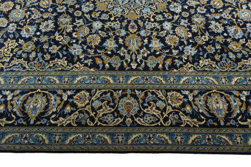 Corner detail of 2000s Kashan rug showing border pattern and Wool pile