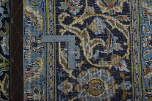 Backside of handmade 2000s Kashan rug showing knot structure and weave density