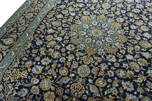 Backside of handmade 2000s Kashan rug showing knot structure and weave density