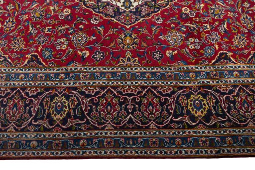 Corner detail of 2000s Kashan rug showing border pattern and Wool pile