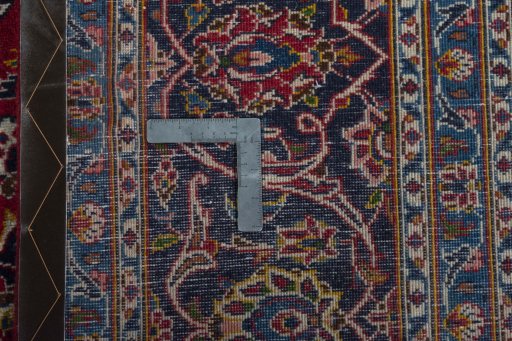 Backside of handmade 2000s Kashan rug showing knot structure and weave density