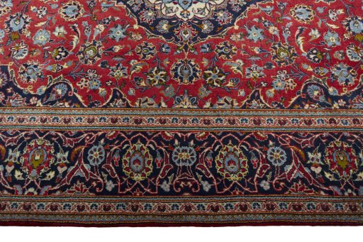Corner detail of 2000s Kashan rug showing border pattern and Wool pile