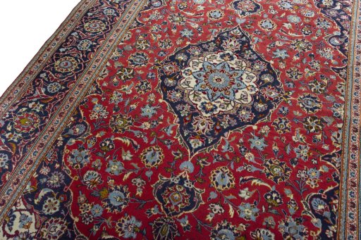 Backside of handmade 2000s Kashan rug showing knot structure and weave density