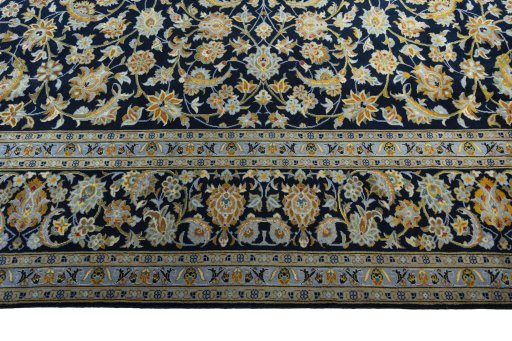Corner detail of 2000s Kashan rug showing border pattern and Wool pile