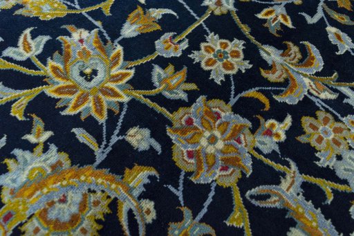 Backside of handmade 2000s Kashan rug showing knot structure and weave density