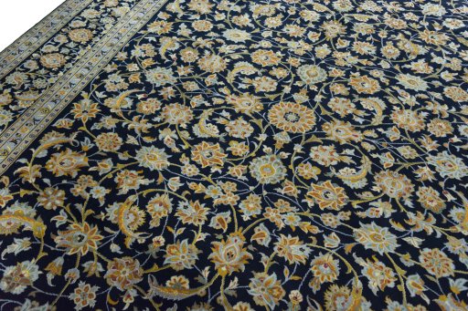 Backside of handmade 2000s Kashan rug showing knot structure and weave density