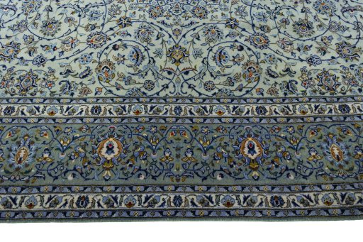 Corner detail of 2000s Kashan rug showing border pattern and Wool pile