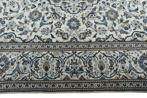 Corner detail of 2000s Kashan rug showing border pattern and Wool pile
