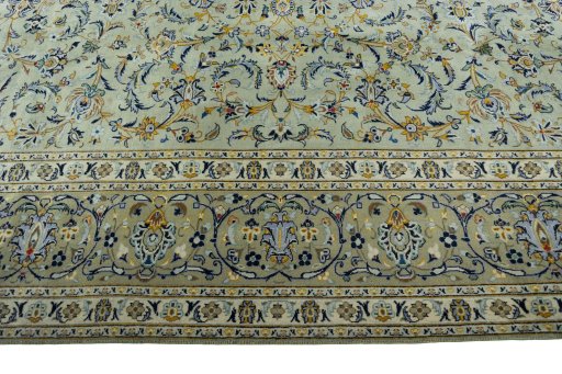 Corner detail of 2000s Kashan rug showing border pattern and Wool pile