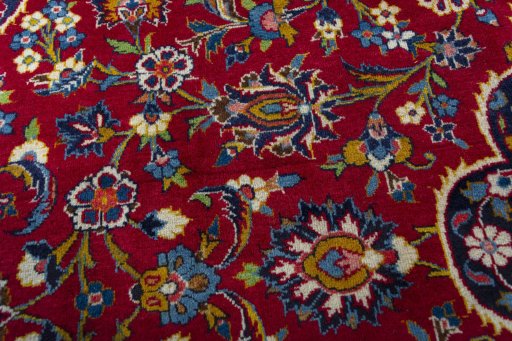 Backside of handmade 1970s Kashan rug showing knot structure and weave density