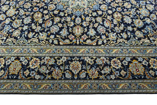 Corner detail of 2000s Kashan rug showing border pattern and Wool pile