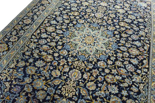 Backside of handmade 2000s Kashan rug showing knot structure and weave density