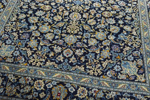 Close-up detail of 2000s Kashan rug from Iran / Persia showing Wool weave
