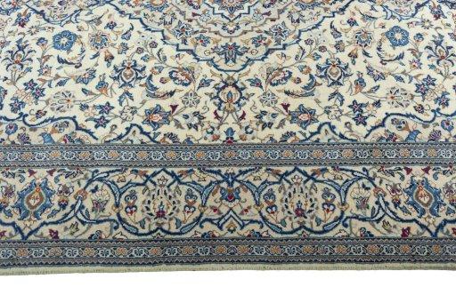Corner detail of 2000s Kashan rug showing border pattern and Wool pile