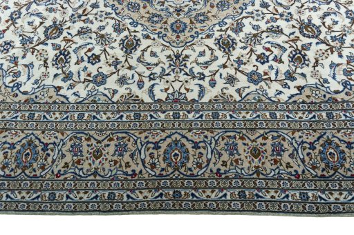 Corner detail of 2000s Kashan rug showing border pattern and Wool pile