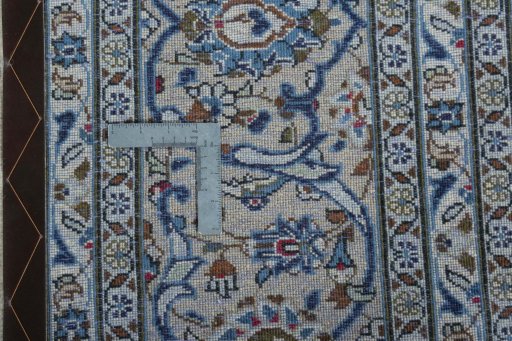 Backside of handmade 2000s Kashan rug showing knot structure and weave density