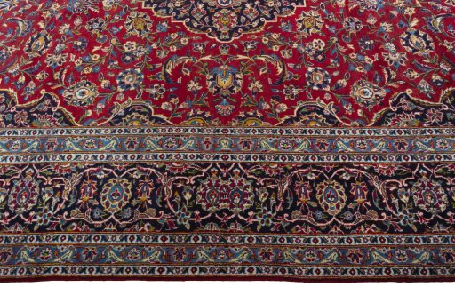 Corner detail of 2000s Kashan rug showing border pattern and Wool pile