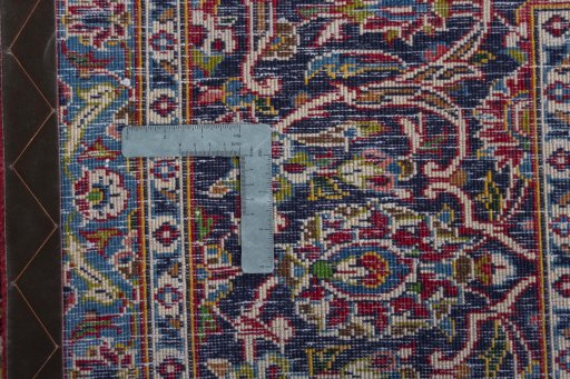 Backside of handmade 2000s Kashan rug showing knot structure and weave density