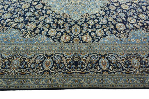 Corner detail of 2000s Kashan rug showing border pattern and Wool pile