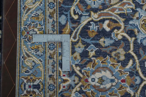 Backside of handmade 2000s Kashan rug showing knot structure and weave density