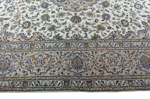 Corner detail of 2000s Kashan rug showing border pattern and Wool pile
