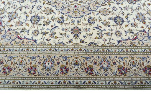 Corner detail of 2000s Kashan rug showing border pattern and Wool pile