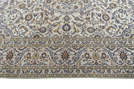 Corner detail of 2000s Kashan rug showing border pattern and Cork pile