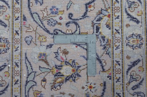 Backside of handmade 2000s Kashan rug showing knot structure and weave density