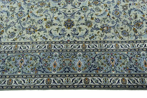 Corner detail of 2000s Kashan rug showing border pattern and Wool pile