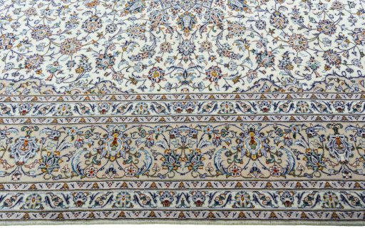 Corner detail of 2000s Kashan rug showing border pattern and Wool pile