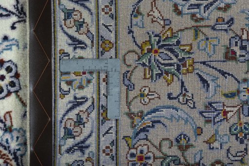 Backside of handmade 2000s Kashan rug showing knot structure and weave density