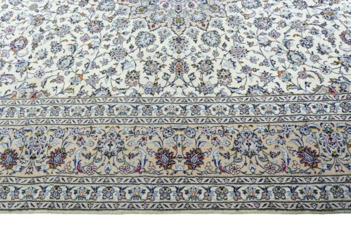 Corner detail of 2000s Kashan rug showing border pattern and Wool pile