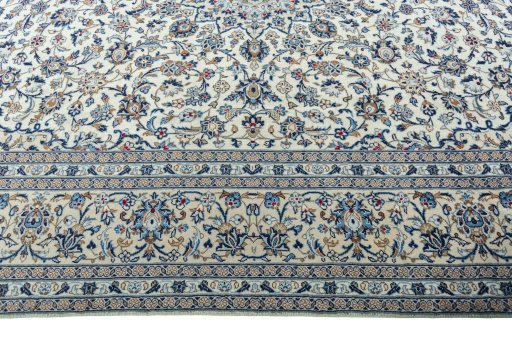 Corner detail of 2000s Kashan rug showing border pattern and Wool pile