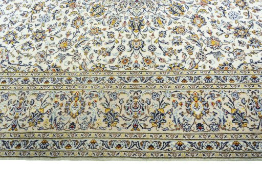 Corner detail of 2000s Kashan rug showing border pattern and Wool pile