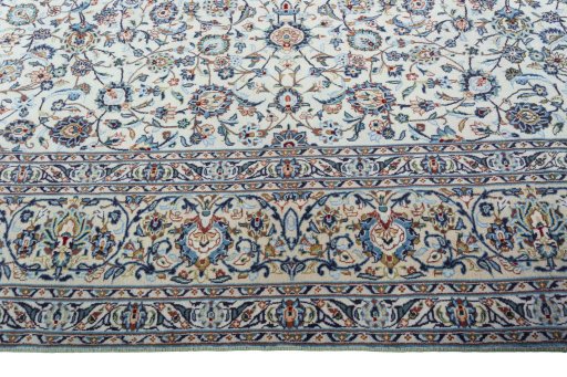 Corner detail of 2000s Kashan rug showing border pattern and Wool pile