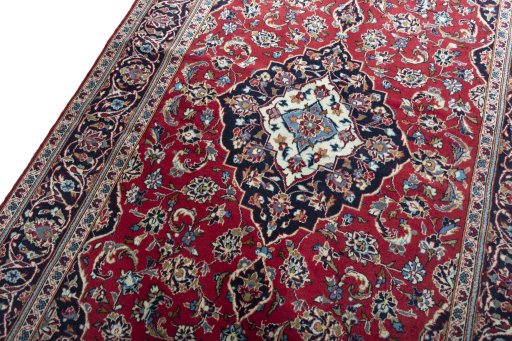 Backside of handmade 2000s Kashan rug showing knot structure and weave density