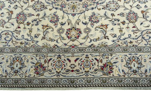 Corner detail of 2000s Kashan rug showing border pattern and Wool pile