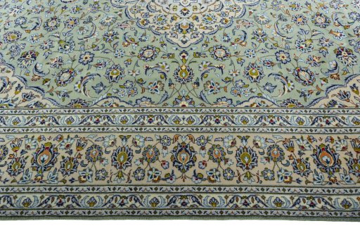 Corner detail of 2000s Kashan rug showing border pattern and Wool pile