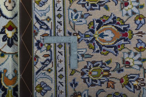 Backside of handmade 2000s Kashan rug showing knot structure and weave density